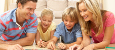 Family Playing Board Game At Home