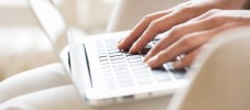 Woman hands typing on a laptop keyboard