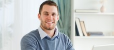 Smiling businessman with laptop in his homeoffice