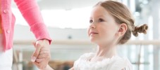 Young daughter holding mothers hand