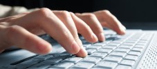 male hands typing on a laptop