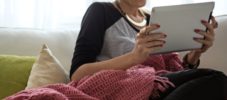 Woman Reading on a Tablet at Home