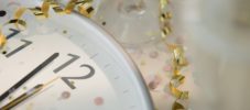 12 o'clock on clock decorated with confetti and streamer
