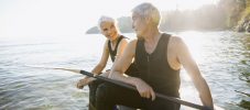 Senior couple on paddle board in ocean