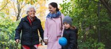 Happy senior woman with daughter and great grandson in park