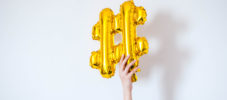 A golden-colored balloon symbol hashtag