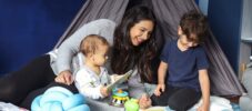 A mother teaching her children with flashcards.