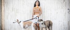 Portrait of a woman enjoying the day with her adorable dogs outdoors on the street in her neighborhood.