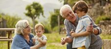 Grandparents talking to children in yard
