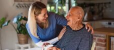 Caregiver or healthcare worker visiting senior man at home.